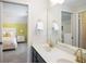 Bathroom featuring a double sink vanity with gold fixtures and a view into the adjacent bedroom at 208 Grandmar, Canton, GA 30115