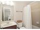 Bathroom featuring a vanity with a dark wood cabinet, a toilet, and a shower with a white curtain at 208 Grandmar, Canton, GA 30115