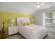 Bedroom featuring bright yellow wallpaper, white bed, ceiling fan and plenty of natural light at 208 Grandmar, Canton, GA 30115