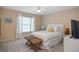 This bedroom features a white ceiling fan, neutral walls, and a comfortable bed with rattan stools at 208 Grandmar, Canton, GA 30115