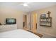 Bedroom featuring neutral walls, carpeted floor, ceiling fan, and a wall shelf with decorations at 208 Grandmar, Canton, GA 30115