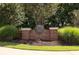 Elegant community entrance featuring brick signage and lush landscaping at 208 Grandmar, Canton, GA 30115
