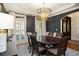 Formal dining room with dark walls, classic trim, white shutters, elegant lighting, and a wooden dining table set at 208 Grandmar, Canton, GA 30115