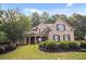 Beautiful two-story brick home with a covered front porch and manicured lawn at 208 Grandmar, Canton, GA 30115