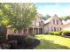 Charming brick home featuring a manicured lawn and a welcoming front porch with stone columns at 208 Grandmar, Canton, GA 30115