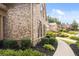 Beautiful home exterior featuring brick facade, landscaped grounds, and a paved pathway leading to the entrance at 208 Grandmar, Canton, GA 30115