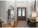 Elegant foyer featuring hardwood floors, a staircase, and stylish decor, leading to other rooms in the home at 208 Grandmar, Canton, GA 30115