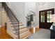 Elegant foyer featuring hardwood floors, a staircase, and stylish decor, leading to other rooms in the home at 208 Grandmar, Canton, GA 30115