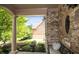 Charming front porch with stone accents, brick columns, and comfortable seating area and landscaped walkway at 208 Grandmar, Canton, GA 30115