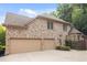Spacious two-car garage with brick exterior, manicured landscaping, and ample parking space at 208 Grandmar, Canton, GA 30115