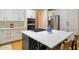 Modern kitchen island with white quartz countertops, a gas cooktop and wine storage at 208 Grandmar, Canton, GA 30115