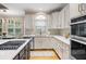 Bright kitchen with stainless appliances, tile backsplash, and an island with a gas cooktop at 208 Grandmar, Canton, GA 30115