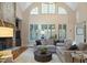 Bright living room features a soaring vaulted ceiling, stone fireplace, and an oversized comfy sectional at 208 Grandmar, Canton, GA 30115