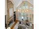 A well lit living room featuring a stone fireplace, large windows, and wood floors at 208 Grandmar, Canton, GA 30115
