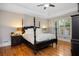 Spacious main bedroom with tray ceilings, hardwood floors, and a stately four-poster bed at 208 Grandmar, Canton, GA 30115