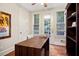 Bright office space featuring wood floors, a large desk, exterior access, and ample natural light at 208 Grandmar, Canton, GA 30115
