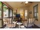 Inviting screened-in sunroom with neutral tones, a ceiling fan, and comfortable seating perfect for relaxing and entertaining at 208 Grandmar, Canton, GA 30115