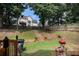 Large backyard with a wooded backdrop includes a grill, patio and tiered garden at 228 Kensington Trce, Stockbridge, GA 30281