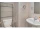 Powder room featuring pedestal sink, toilet, and storage at 228 Kensington Trce, Stockbridge, GA 30281