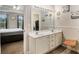 Bathroom featuring double sink vanity, chair and view to main bedroom at 228 Kensington Trce, Stockbridge, GA 30281