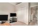 Bedroom featuring closet, TV and office desk at 228 Kensington Trce, Stockbridge, GA 30281