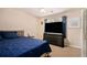 This bedroom boasts a ceiling fan, large TV, and comfortable bed, creating a relaxing retreat at 228 Kensington Trce, Stockbridge, GA 30281