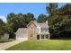 Charming two-story home featuring a brick and siding exterior, landscaped lawn, and attached two-car garage at 228 Kensington Trce, Stockbridge, GA 30281