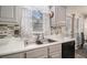 Close-up of a modern kitchen countertop featuring a mosaic backsplash, stainless steel sink, and stylish faucet at 228 Kensington Trce, Stockbridge, GA 30281