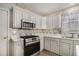 Charming kitchen with stainless steel oven and mosaic tile backsplash at 228 Kensington Trce, Stockbridge, GA 30281
