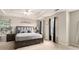 Main bedroom featuring tray ceiling, a bed and bedside tables at 228 Kensington Trce, Stockbridge, GA 30281