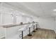 Finished basement featuring a custom bar with sleek, white stools at 2436 Ovidia Sw Cir, Atlanta, GA 30311