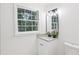 Bright bathroom featuring granite counters, vanity, brushed nickel fixtures and natural light at 2436 Ovidia Sw Cir, Atlanta, GA 30311