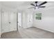 Bright bedroom with neutral carpet, ceiling fan, and double closet doors at 2436 Ovidia Sw Cir, Atlanta, GA 30311