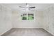 Inviting bedroom featuring wood-paneled walls and a view of the yard at 2436 Ovidia Sw Cir, Atlanta, GA 30311