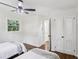 Bedroom with wood floors, ceiling fan, closet, and natural light at 2436 Ovidia Sw Cir, Atlanta, GA 30311