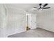 Light-filled bedroom showcasing wood-paneled walls and a ceiling fan at 2436 Ovidia Sw Cir, Atlanta, GA 30311