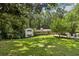 Scenic view of a charming home with a well-manicured lawn and mature trees at 2436 Ovidia Sw Cir, Atlanta, GA 30311