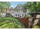 Backyard with lush greenery, mature trees, and patio on the rear of a two-story home at 2436 Ovidia Sw Cir, Atlanta, GA 30311