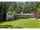 Charming exterior view of home with lush landscaping and mature trees, offering privacy and curb appeal at 2436 Ovidia Sw Cir, Atlanta, GA 30311