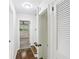 Hallway view leading to a bedroom with a ceiling fan and an open storage area at 2436 Ovidia Sw Cir, Atlanta, GA 30311