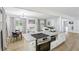 Open concept kitchen flows to living room with fireplace, wood floors, granite countertops, and stainless appliances at 2436 Ovidia Sw Cir, Atlanta, GA 30311