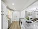 Open kitchen with granite countertops, stainless appliances, breakfast bar and open view to living area at 2436 Ovidia Sw Cir, Atlanta, GA 30311