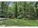 Green backyard with mature trees and foliage, providing a private, serene outdoor setting at 2436 Ovidia Sw Cir, Atlanta, GA 30311