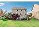 Backyard view featuring a spacious deck and stairs leading to a lush lawn at 4710 Robins Nest Ln, Cumming, GA 30041