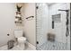 Modern bathroom featuring white subway tile, stylish patterned floor, and a frameless glass shower enclosure at 4710 Robins Nest Ln, Cumming, GA 30041