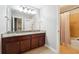 Bright bathroom boasts double sinks, granite countertops, and a tiled shower/tub combination at 4710 Robins Nest Ln, Cumming, GA 30041