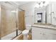 Bathroom with a walk-in shower, granite countertop vanity, modern fixtures, and tile flooring at 4710 Robins Nest Ln, Cumming, GA 30041