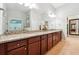 Elegant bathroom features double sinks, granite countertops, and ample cabinet storage at 4710 Robins Nest Ln, Cumming, GA 30041