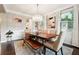 Elegant dining room with a large wood table, stylish chairs, and a modern chandelier creating a sophisticated space at 4710 Robins Nest Ln, Cumming, GA 30041