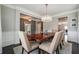 Stylish dining room featuring a modern chandelier, wood table, and elegant trim work at 4710 Robins Nest Ln, Cumming, GA 30041